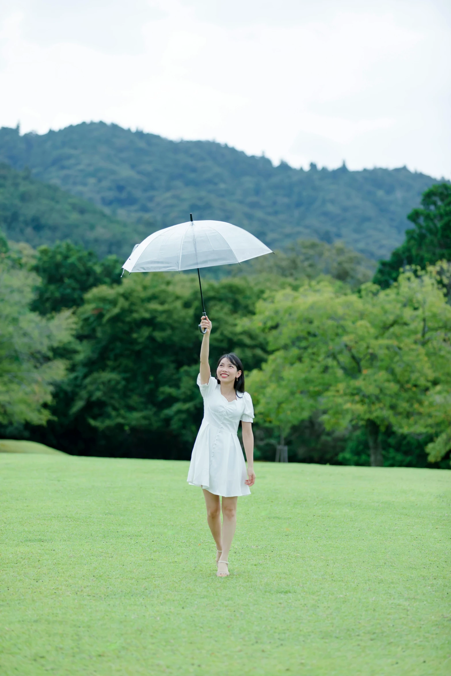 a woman in a white dress holding an umbrella, by Katsukawa Shun'ei, unsplash, visual art, on a green hill between trees, in karuizawa, on a green lawn, actress