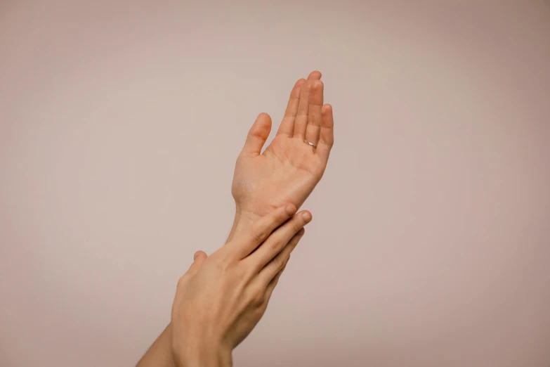 a person holding their hand up in the air, aestheticism, smooth pink skin, cysts, acupuncture treatment, slightly turned to the right