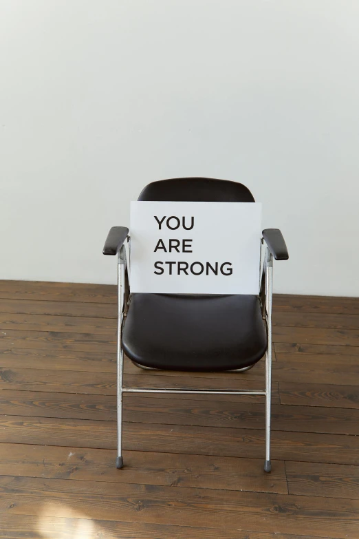 a chair with a sign that says you are strong, by Nina Hamnett, dada, lgbtq, demur, yoshiyuki sadamoto, personal