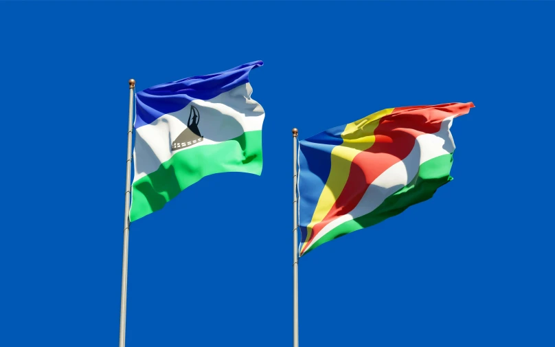 two flags blowing in the wind against a blue sky, by Julia Pishtar, shutterstock, renaissance, madagascar, avatar image, multi - coloured, 15081959 21121991 01012000 4k