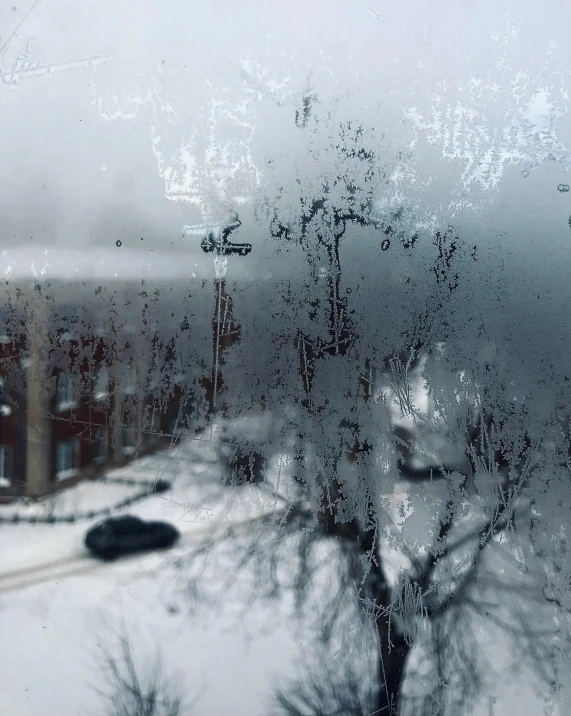 a view of a street through a window covered in snow, an album cover, pexels contest winner, scary sharp icy, scratches on photo