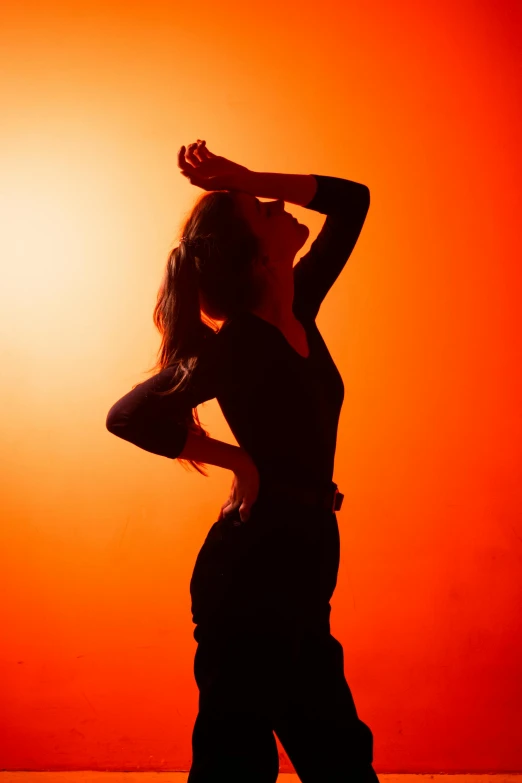 a woman is silhouetted against an orange background, pexels, sensual dancing, concerned, portrait of tall, flare