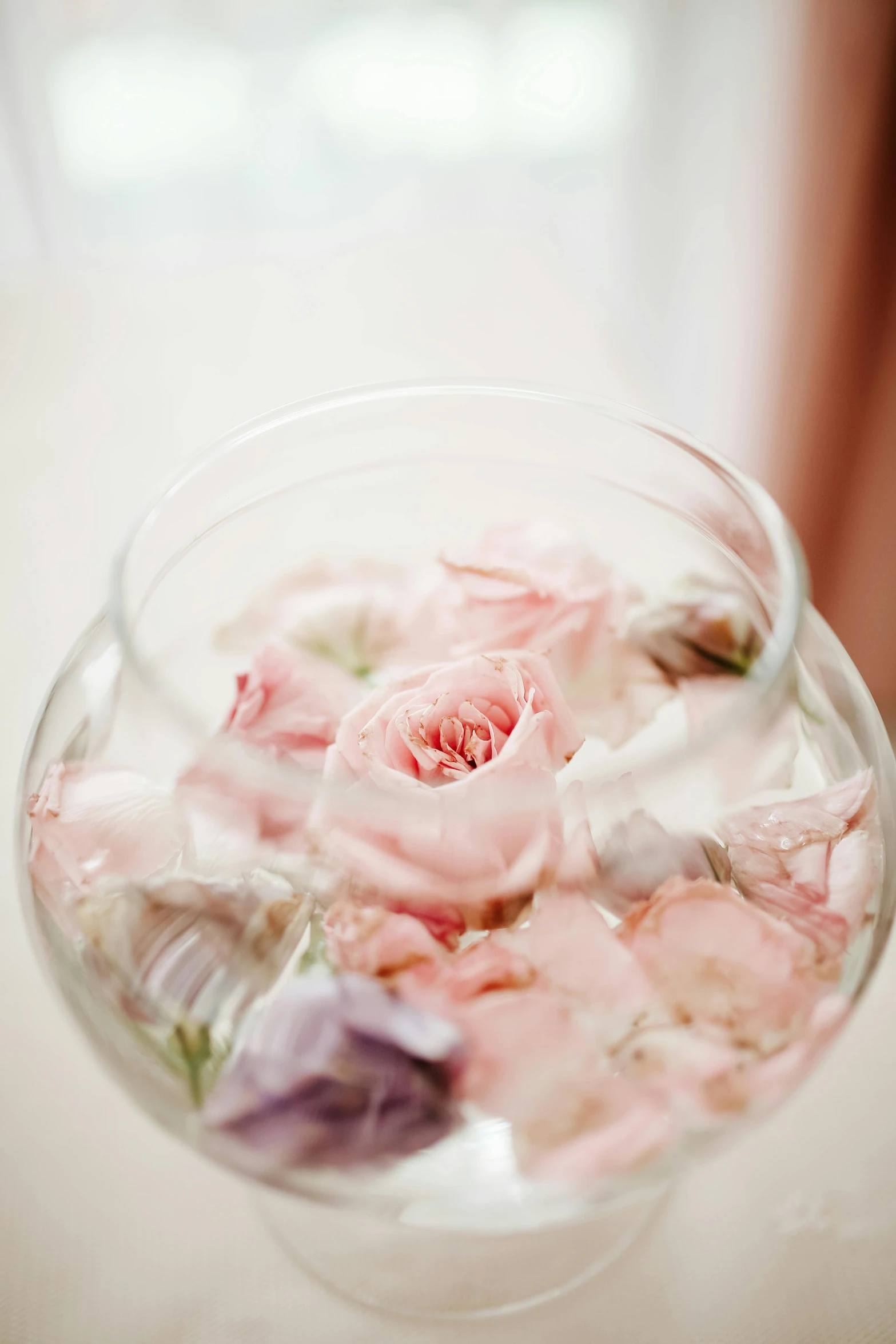 a glass vase filled with flowers on top of a table, pink rose, in detail, floating pieces, soft tones