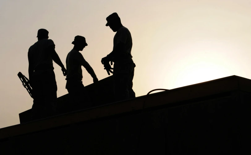 a group of men standing on top of a roof, pexels contest winner, constructivism, profile image, first light, working hard, backlighted