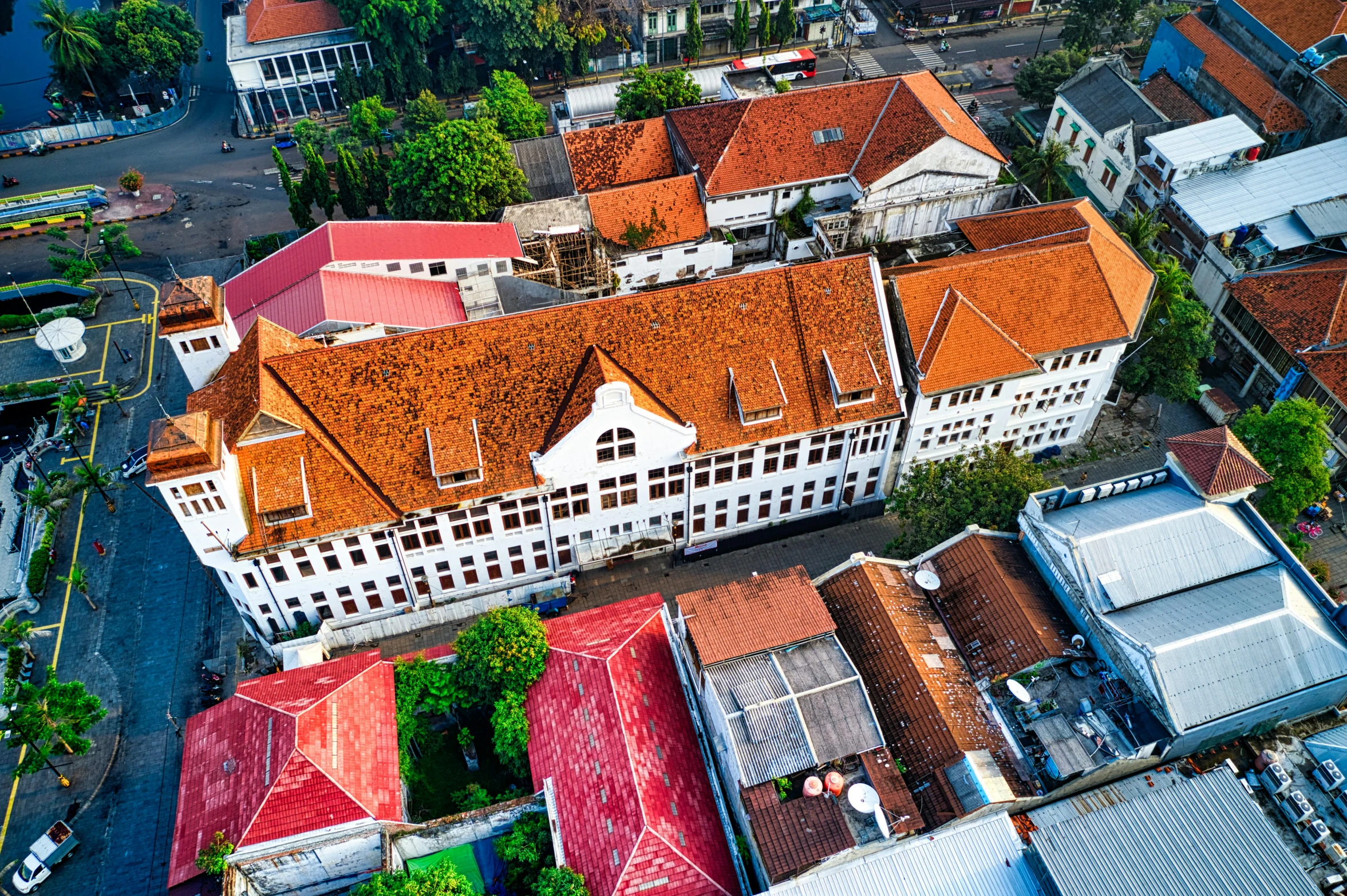 an aerial view of a building with a red roof, inspired by Erik Pevernagie, heidelberg school, jakarta, old town, white building, exterior photo