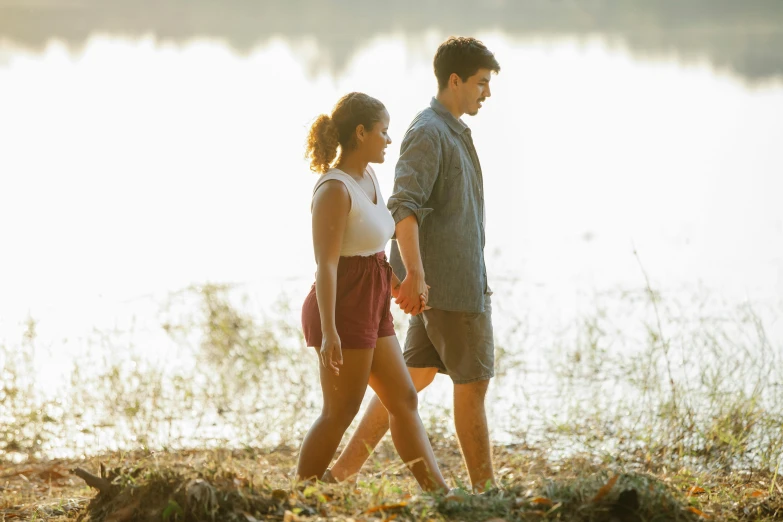 a man and a woman walking next to a body of water, by John Luke, the movie, sydney park, holding hands, profile image