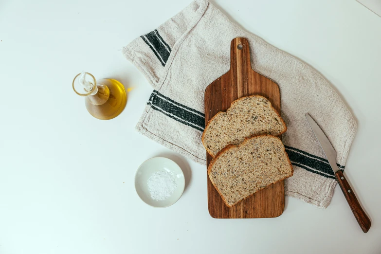 a wooden cutting board topped with slices of bread, a still life, unsplash, cooking oil, linen, full body image, 4l