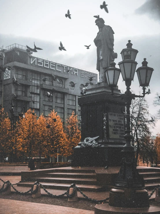 a black and white photo of a statue in front of a building, inspired by Fyodor Vasilyev, pexels contest winner, socialist realism, gray and orange colours, during autumn, city square, 000 — википедия