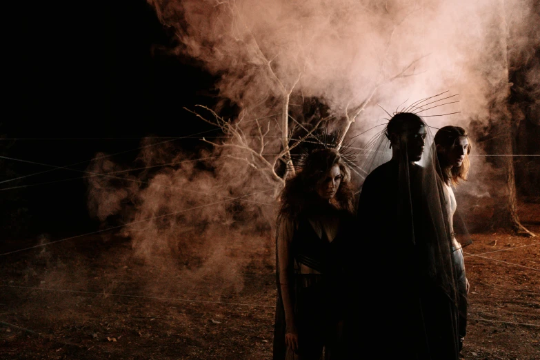 a group of people standing next to each other, a portrait, pexels contest winner, conceptual art, smoke and embers, halloween scene, profile image, film still promotional image