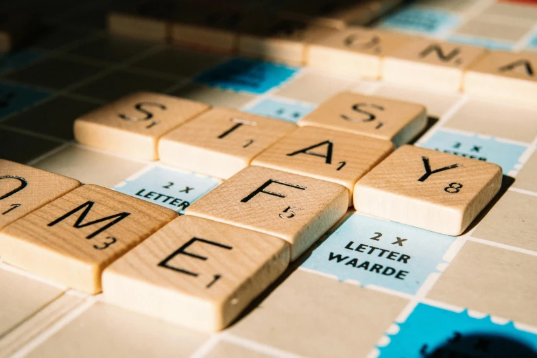 a close up of scrabble tiles on a table, by Emma Andijewska, pexels contest winner, letterism, slay, thumbnail, fable, take me away from the norm '