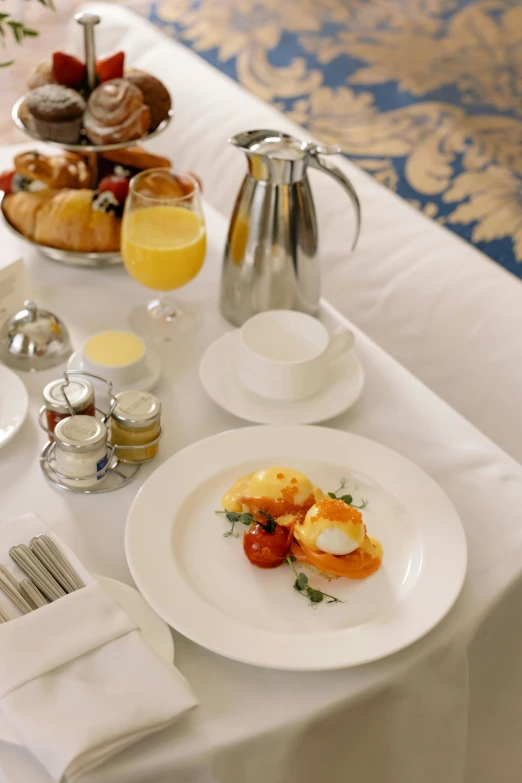 a white table topped with plates of food, in the morning, stately, breakfast, offering a plate of food