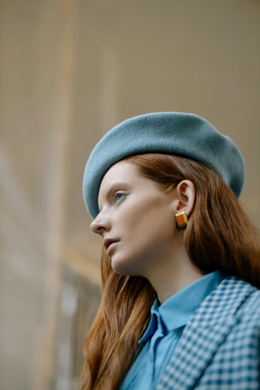 a woman with long red hair wearing a blue hat, inspired by Elsa Bleda, trending on pexels, earring, wearing a beret, squares, muted colors. ue 5