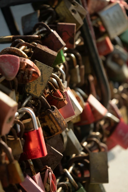 a bunch of padlocks attached to a fence, an album cover, unsplash, romanticism, slide show, on a bridge, more