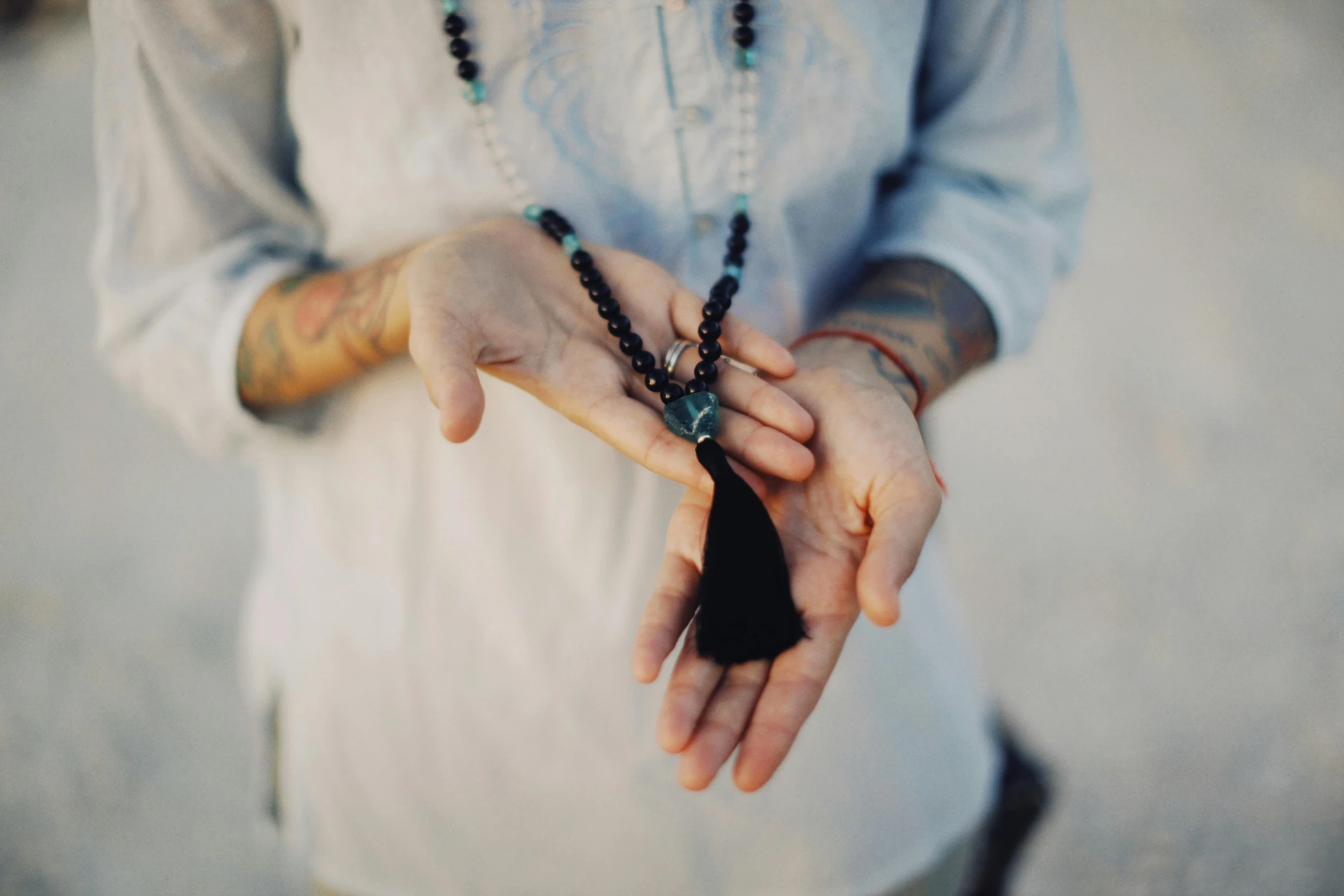 a close up of a person holding a necklace, unsplash, kundalini energy, holding nevermore, instagram photo, hands crossed