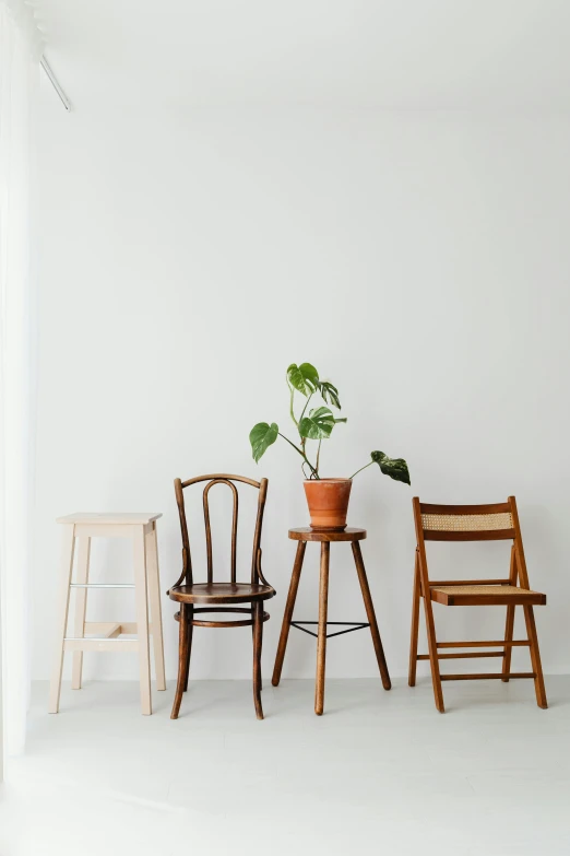 three chairs and a table in a white room, inspired by Constantin Hansen, trending on unsplash, portrait of tall, brown, standing on a shelf, from left