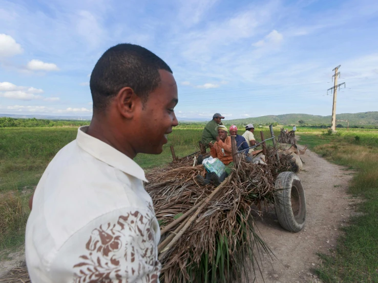 a group of people riding on the back of a cart, madagascar, background image, sustainability, thumbnail