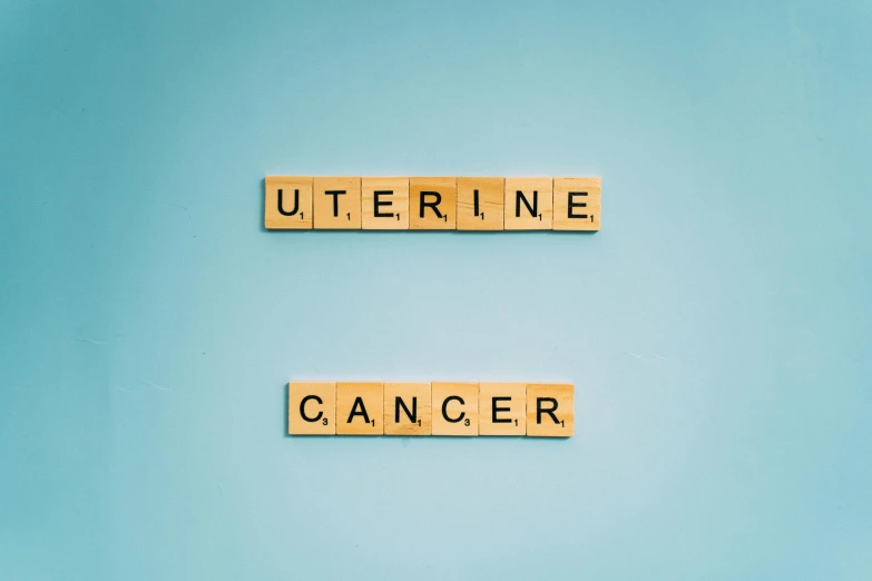 wooden scrabbles spelling uterine cancer on a blue background, an album cover, by Julia Pishtar, shutterstock, unedited, octane ue 5, urine collection bag, octane 8