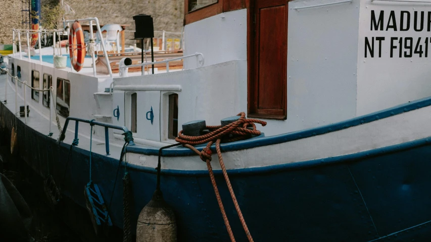 a close up of a boat in a body of water, by Raphaël Collin, pexels contest winner, docked at harbor, wes anderson style, thick blue lines, low quality photo