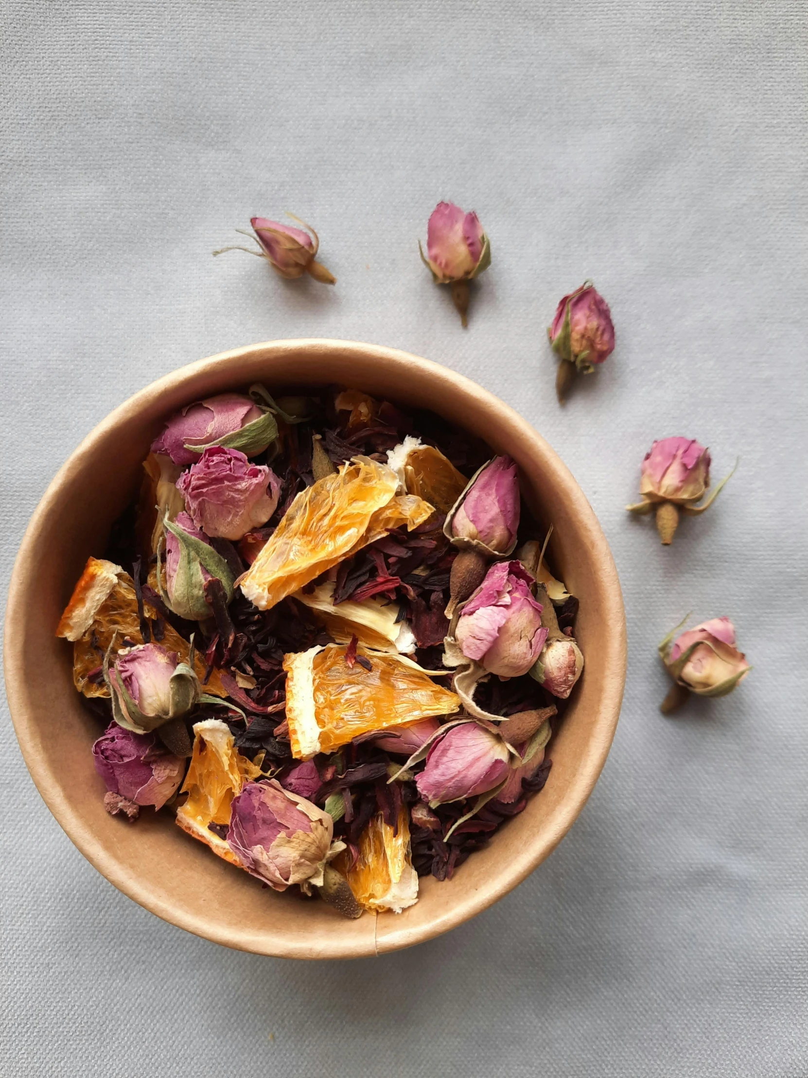 a bowl filled with dried flowers on top of a table, rose petals, in a style blend of botticelli, orange, thumbnail