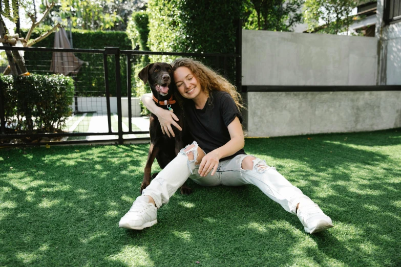 a woman sitting on the grass with a dog, alana fletcher, with black, all around, pokimane