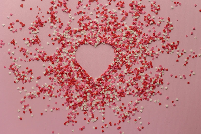 a heart made out of confetti sprinkles on a pink background, by Georgina Hunt, pexels, visual art, 15081959 21121991 01012000 4k, flowers around, sweets, pink shadows