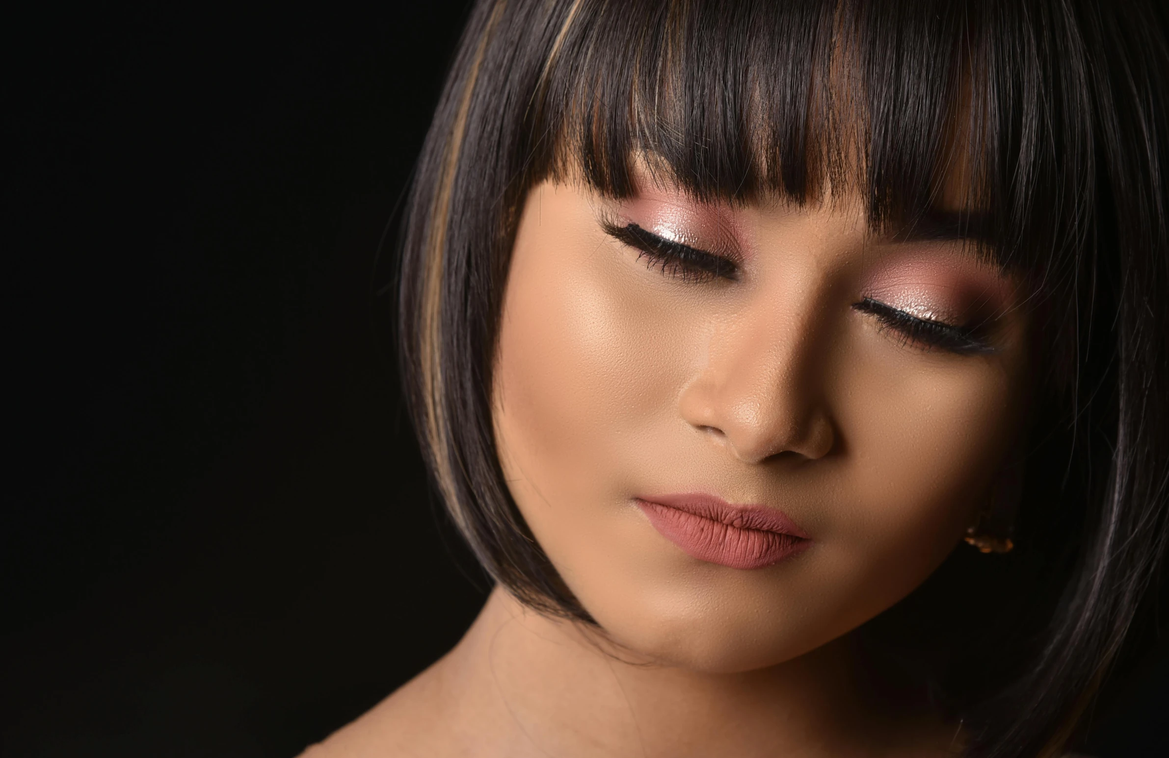 a close up of a woman holding a cell phone, an album cover, inspired by Natasha Tan, hurufiyya, makeup. unreal engine, with a black background, asian human, taken with sony alpha 9