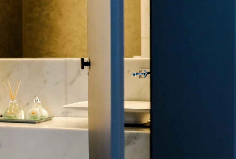 a bathroom with a sink and a mirror, a marble sculpture, inspired by Richmond Barthé, unsplash, private press, opposite the lift-shaft, grey and blue theme, about to enter doorframe, carefully crafted