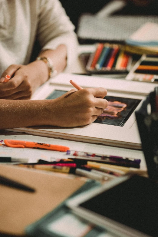 a person sitting at a table with a book, a drawing, pexels contest winner, academic art, crayons on paper, in a workshop, digital design, art station trending