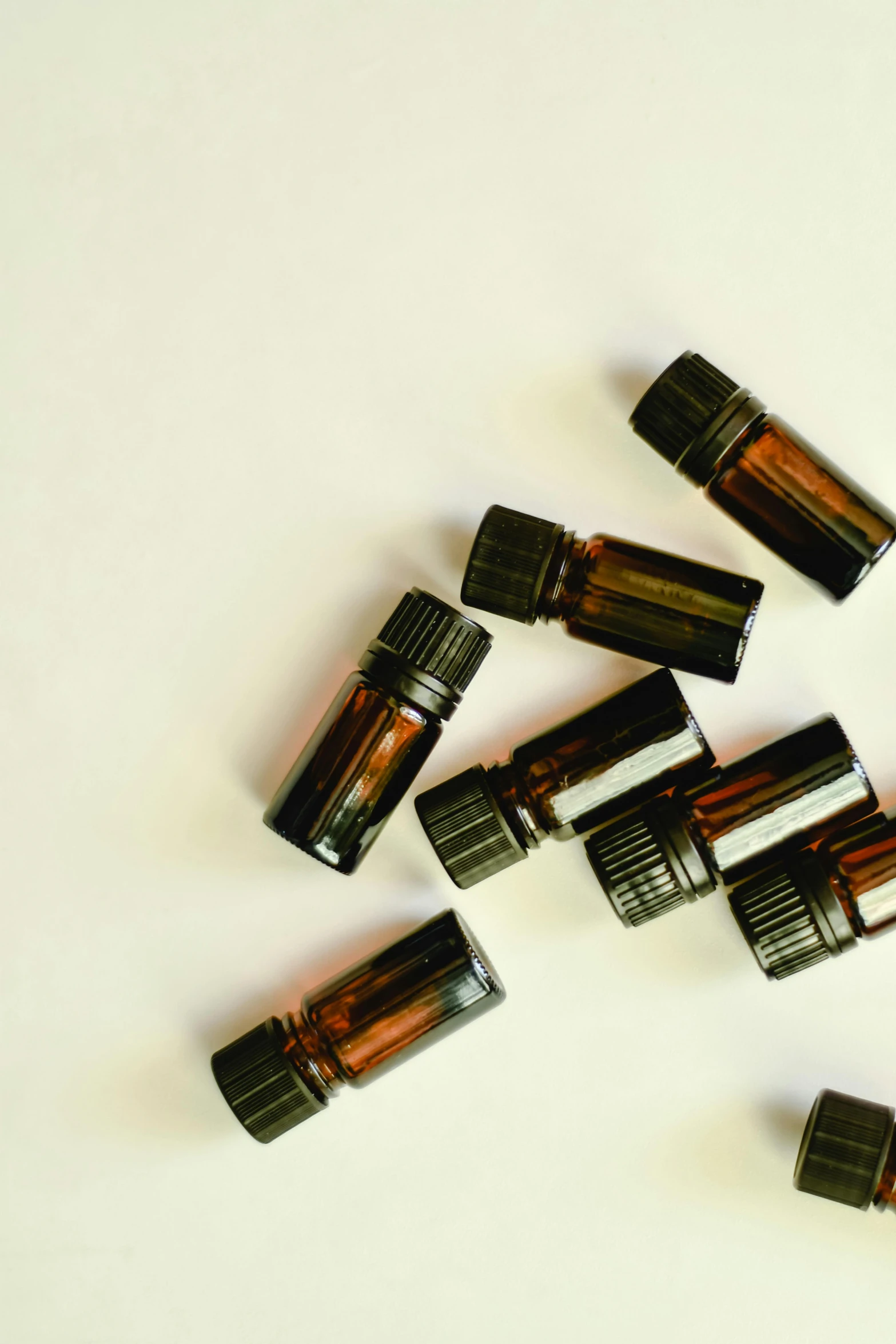 several small bottles of essential oils on a white surface, by Gavin Hamilton, pexels, visual art, thumbnail, 2717433015, bolts, brown