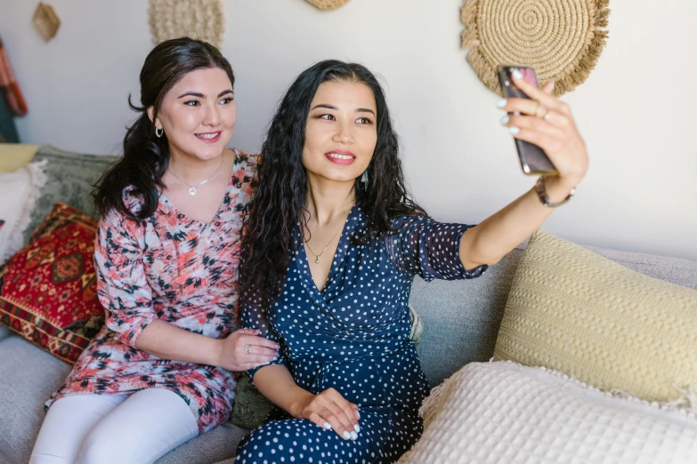 two women sitting on a couch taking a selfie, instagram, hurufiyya, background image, headshot photoshoot, avatar image, professional image