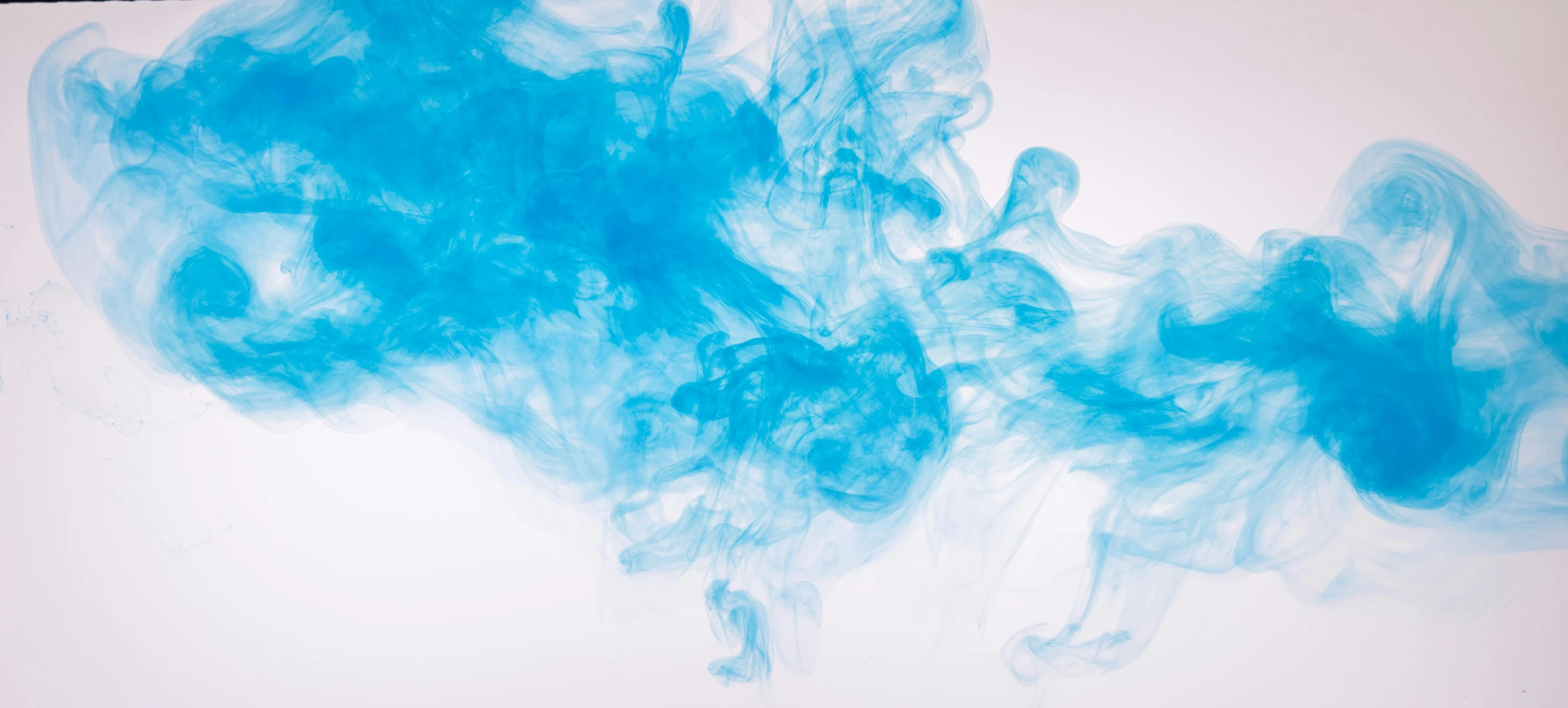 a laptop computer sitting on top of a desk covered in blue ink, trending on pexels, lyrical abstraction, bright blue smoke, turquoise, with a white background, underwater ink