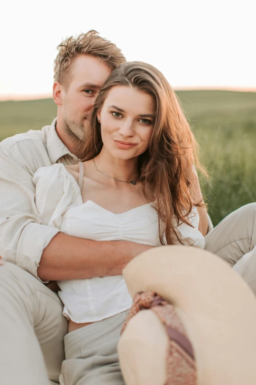 a man and woman sitting on a couch in a field, a picture, trending on pexels, handsome girl, wearing a linen shirt, prairie, head shot