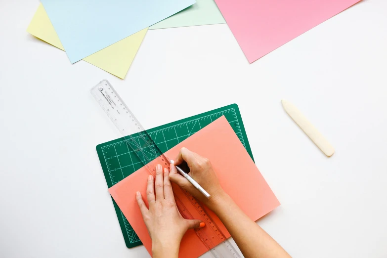 a person cutting paper with a pair of scissors, trending on unsplash, arbeitsrat für kunst, square lines, colourful drawing, schools, fan favorite