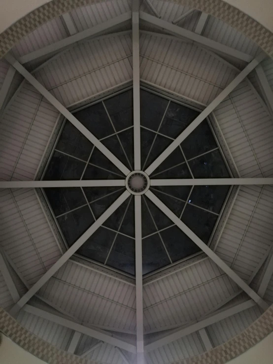 a clock mounted to the ceiling of a building, by Carey Morris, unsplash, conceptual art, interior of a tent, symmetrical complex fine detail, grayish, upon a peak in darien