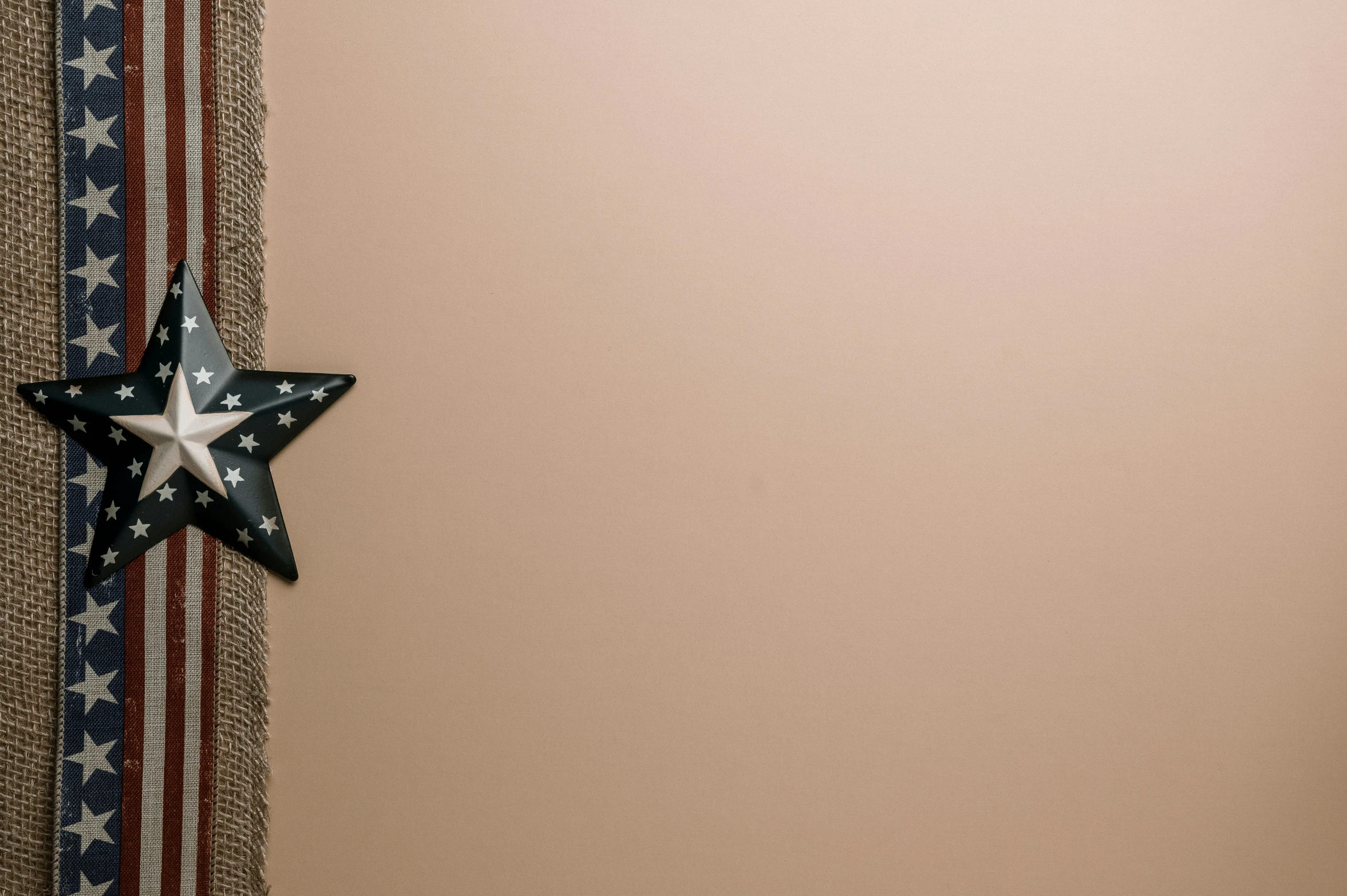 a close up of a star on a wall, trending on pexels, beige background, burlap, wall corner, bronze