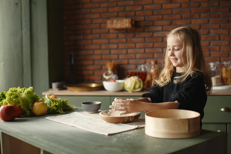 a little girl that is sitting at a table, inspired by Martinus Rørbye, pexels contest winner, wooden bowl, for displaying recipes, ingredients on the table, high quality product photo