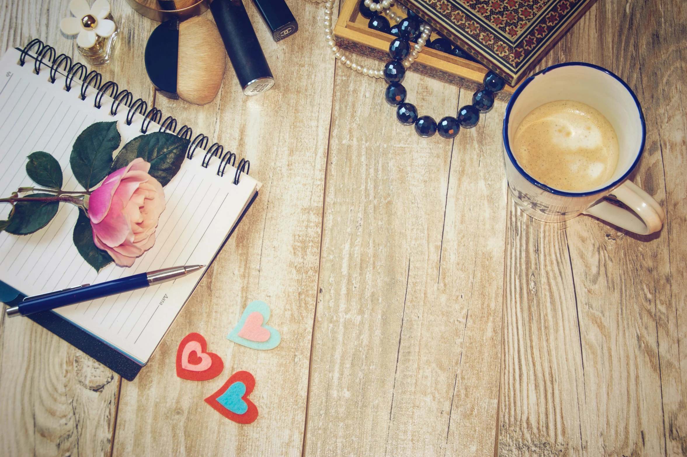 a notepad sitting on top of a wooden table next to a cup of coffee, by Julia Pishtar, romanticism, bracelets and necklaces, thumbnail, islamic, love craft