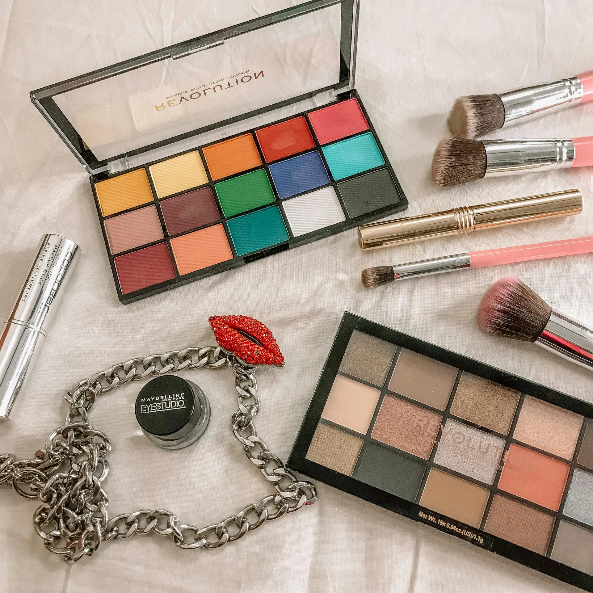 a variety of makeup products laid out on a bed, a picture, trending on pexels, bauhaus, multi colored, outfit photo, gothic makeup, rectangle