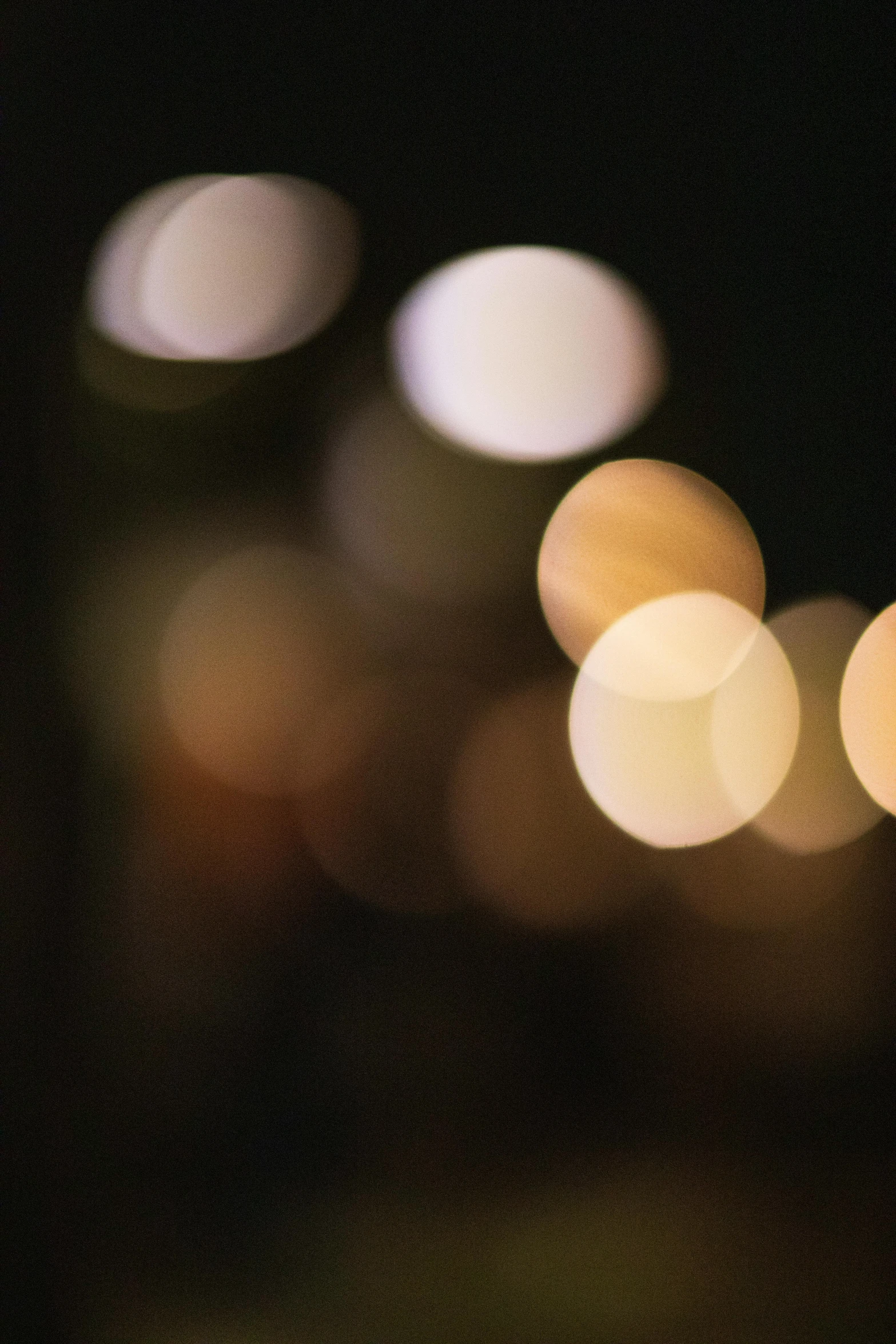 a blurry photo of a city at night, unsplash, tonalism, macro bokeh ”, soft light - n 9, translucent orbs, candlelit