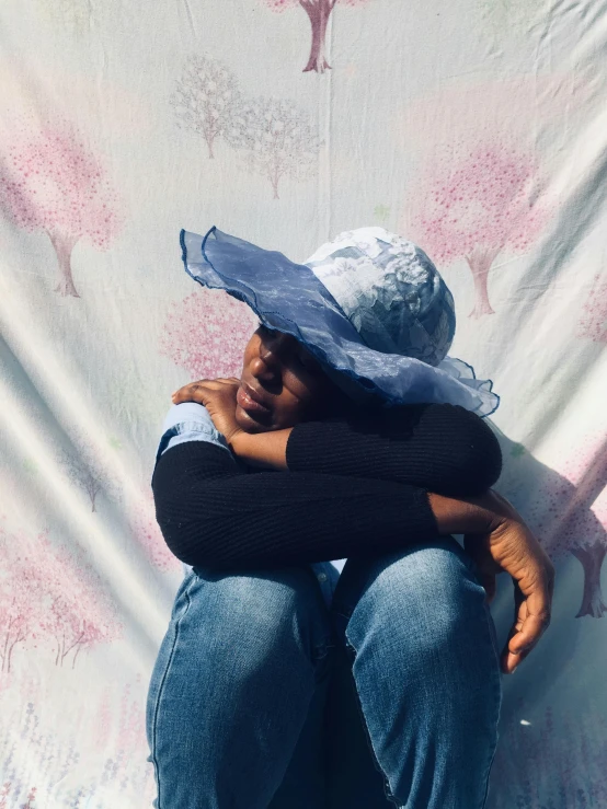 a woman sitting on the ground wearing a hat, an album cover, by Dulah Marie Evans, hyperrealism, ((blue)), wearing translucent sheet, sakura season, childhood friend vibes