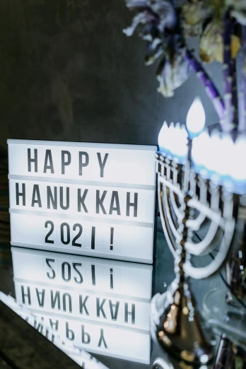 a bunch of books sitting on top of a table, by Emanuel Witz, hurufiyya, party lights, year 2 0 2 2, sukkot, candy decorations