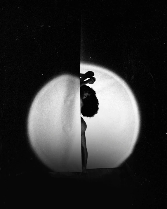 a black and white photo of a flower in a vase, inspired by Carrie Mae Weems, conceptual art, sitting on a moon, woman silhouette, image split in half, ffffound