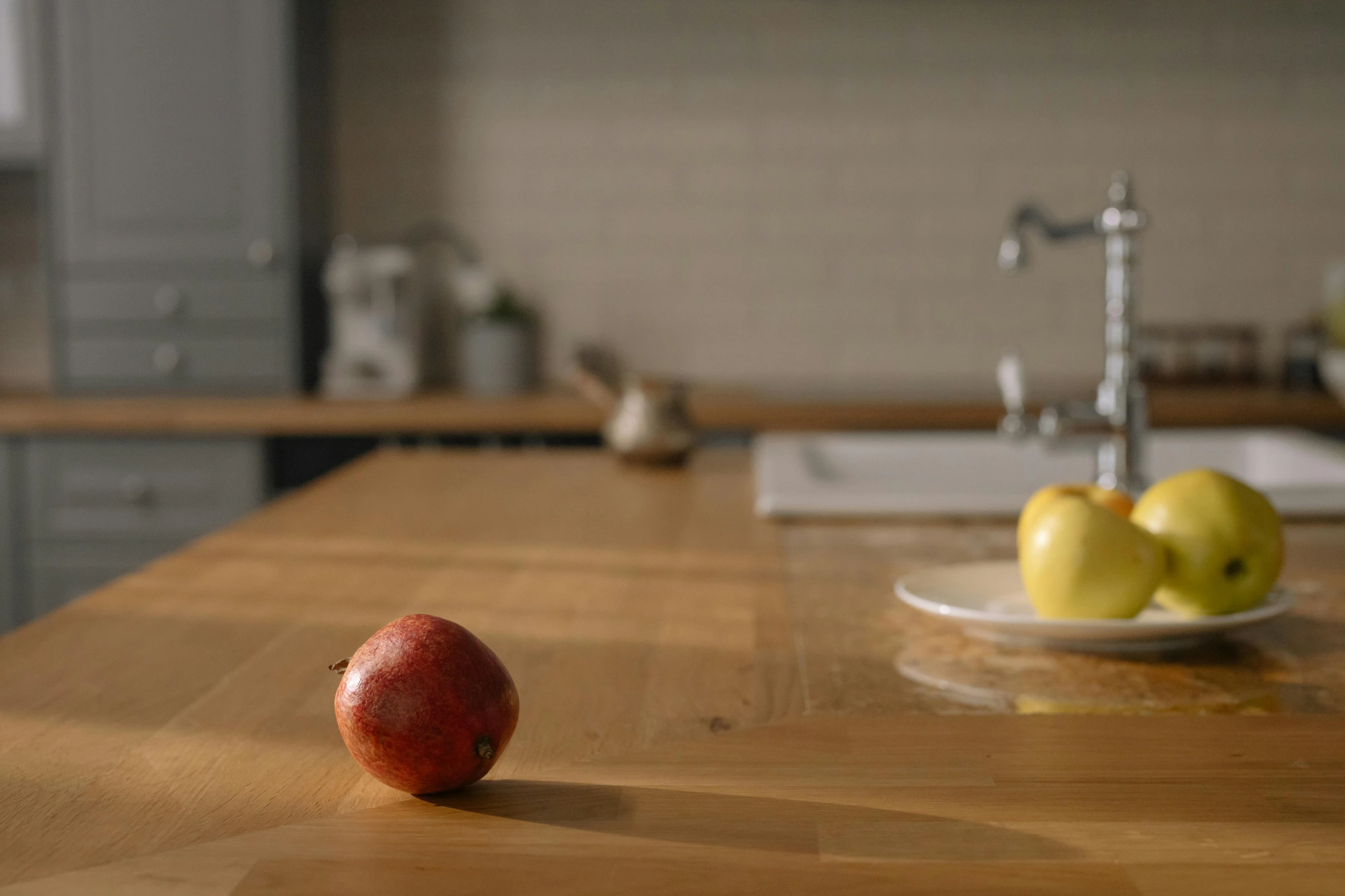 a red apple sitting on top of a wooden counter, inspired by Richard Wilson, archviz, natural wood top, brown, at the counter