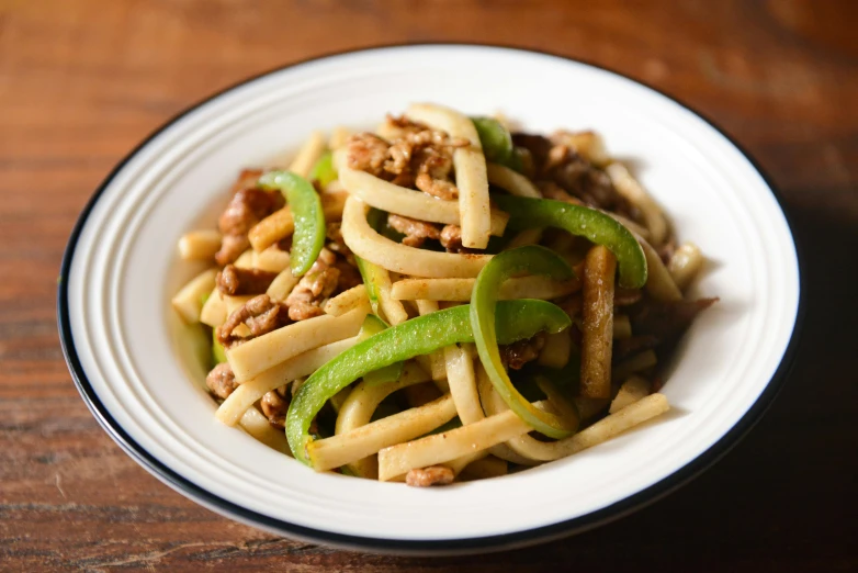 a close up of a plate of food on a table, inspired by Wang Mian, pasta, ground meat, green, pepper