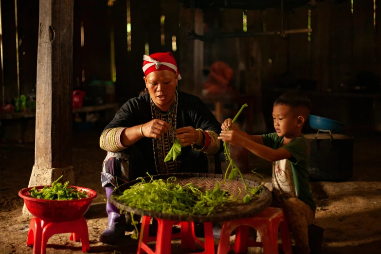 a man sitting at a table with a child, pexels contest winner, woman made of plants, laos, avatar image, thumbnail