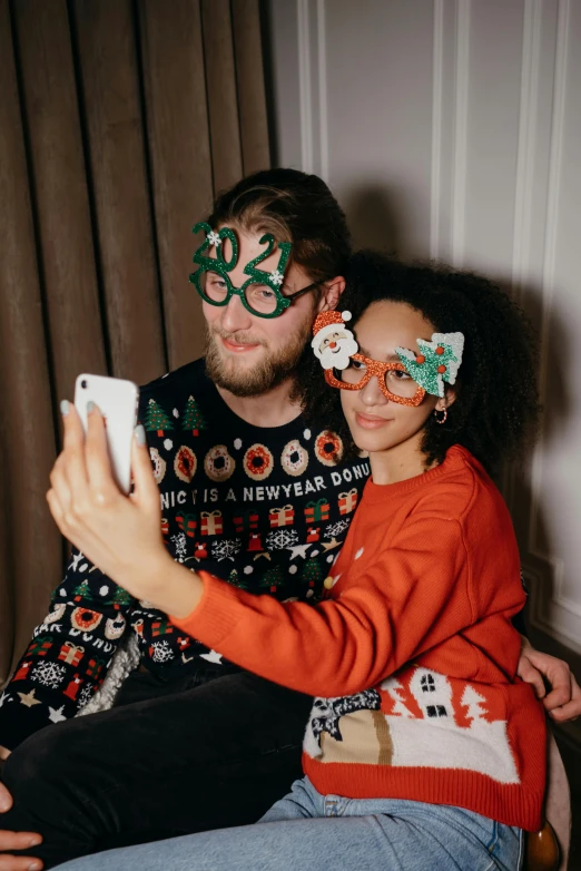 a man and a woman taking a selfie, wearing festive clothing, amber glasses, caspar david, profile image