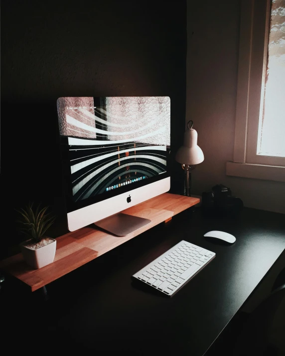 a computer monitor sitting on top of a wooden desk, trending on vsco, well decorated, iphone photo, pitch black room