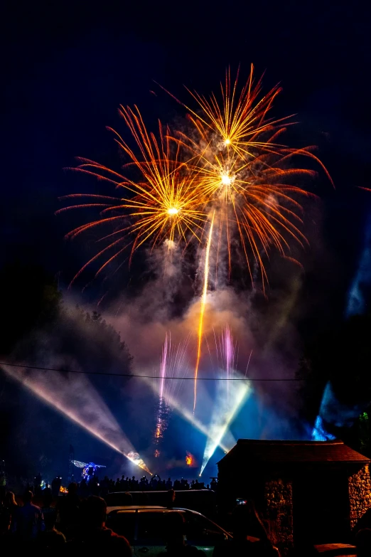 a group of people watching fireworks in the sky, elaborate stage effects, thumbnail, an award winning photo, dramatic lighting - n 9