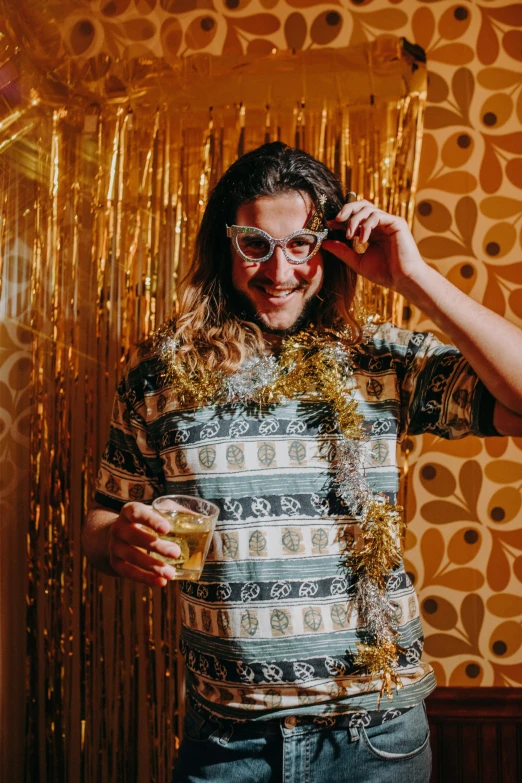 a man standing in front of a mirror talking on a cell phone, a polaroid photo, by Jessie Alexandra Dick, trending on pexels, maximalism, wearing festive clothing, wavy hair yellow theme, drinking beer and laughing, glitter gif