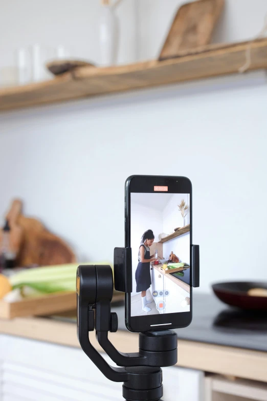 a cell phone sitting on top of a tripod, on kitchen table, anamorphic, everything fits on the screen, detailed product image